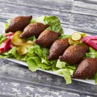 Fried Kibbee · 6 pieces. Football-shaped shells of cracked wheat stuffed with seasoned meat and pine nuts.