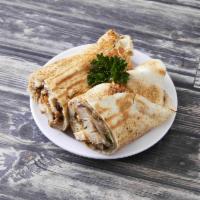 Chicken Shawarma Sandwich · Slow roasted and shaved dark chicken meat with garlic sauce and pickles.