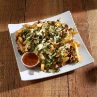 Carne Asada Fries · French fries smothered with green chili, cheese, carne asada, onions, cilantro, poblano sour...
