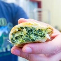 Spinach Empanada · Steamed spinach, ricotta, mozzarella and Parmesan cheeses, sauteed onions and spices. 