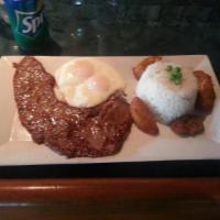 Bistec a lo Pobre · Steak, beans, plantains, eggs and rice. 