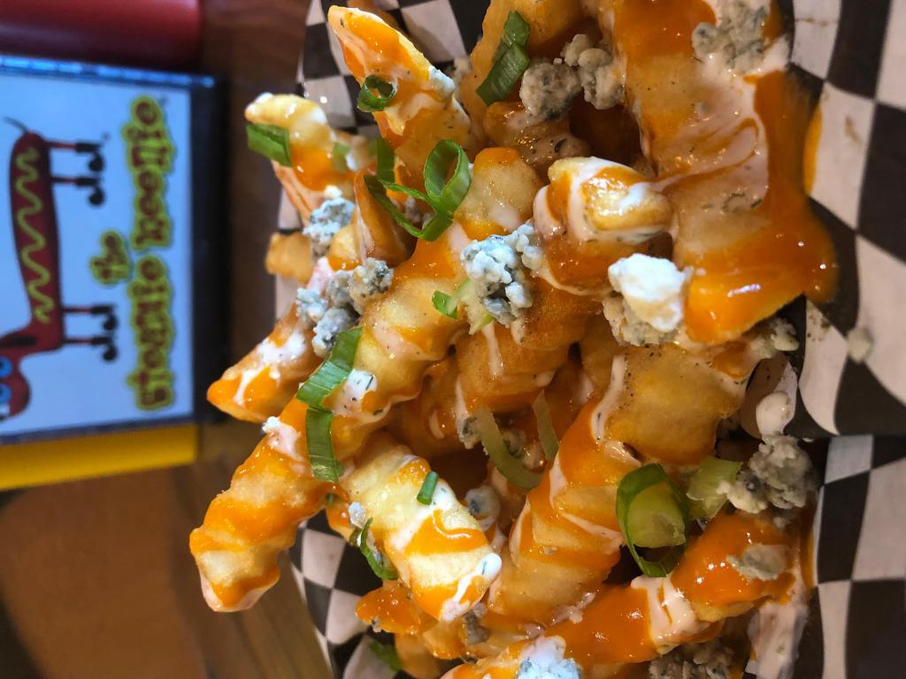 Buffalo Fries · Crinkle cut fries with tangy buffalo sauce, buttermilk ranch, bleu cheese crumbles and green onions