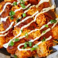 Loaded Baked Potato Tots · Tots, bacon, scallions, sour cream and shredded cheddar cheese.