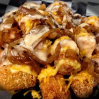 Doggie-Style Tots · Tots topped with beer cheese, cheddar cheese, grilled onions and Steamie Sauce.