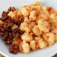 Shrimp with Candied Walnuts · Crunchy shrimp tossed in a creamy white sauce with a touch of citrus and are topped with a g...