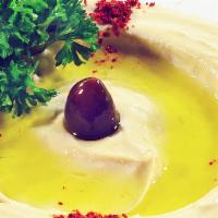 Hummus · Pureed garbanzo beans, fresh lemon juice and tahini sauce combined to form a dip. Served wit...