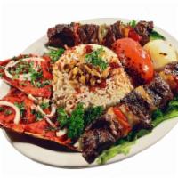 Beef Kabob Entree · Tender filet Mignon marinated and grilled with bell peppers and onions. Served with hummus, ...