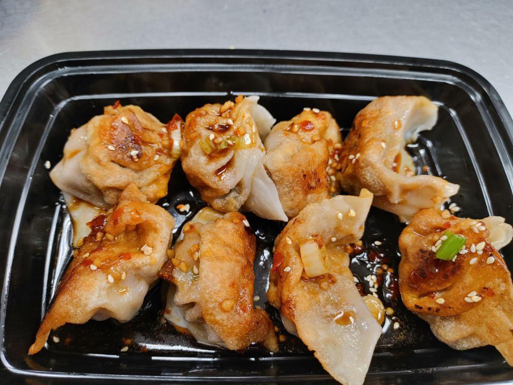 Pan Fried Pork Dumpling(8) · Simple flour dough wrapping filled with seasoned ground pork mixed with scallion, ginger and chives. Served with house dipping sauce.