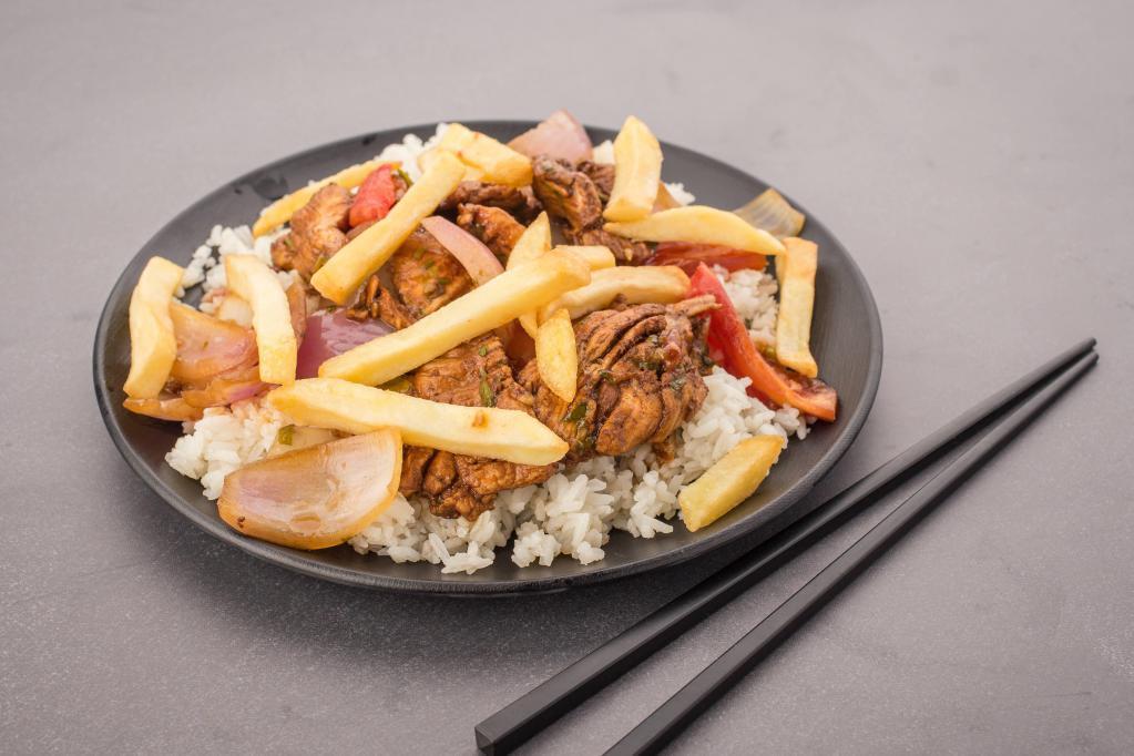 Pollo Saltado · Sauteed chicken, onions and tomatoes served with fries and rice.