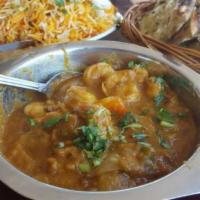 House Shrimp Curry · Shrimp, cooked in onion tomato and special house spices. Served with cup of rice or 1 butter...
