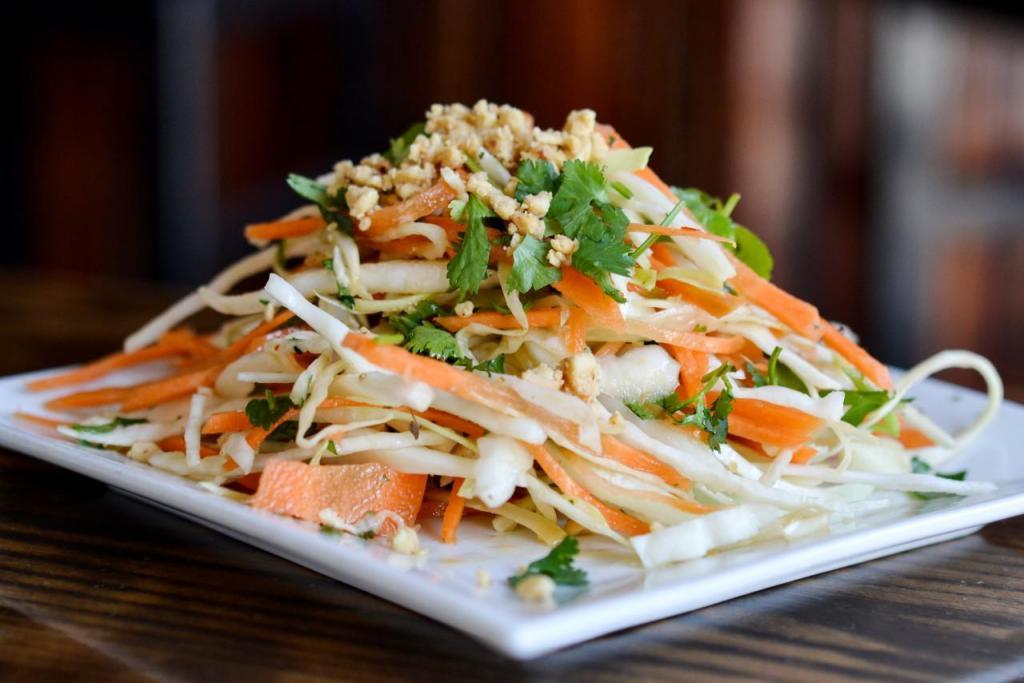 Thai Cabbage Salad · Cabbage, carrot, cilantro, cucumber, peanuts and thai vinaigrette. Vegan