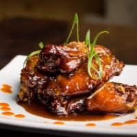 Chicken Wings · Served with tamarind chili sauce. Spicy.