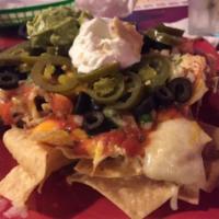 Nachos · Choice of marinated chicken or ground beef topped with cheese, pico de gallo, guacamole and ...