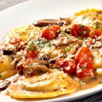 Ravioli Di Bello · Portobello ravioli, crimini mushrooms, roasted grape tomatoes, Grana Padano Zanetti, fresh t...
