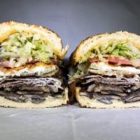 444. The Bear Hug · Thinly sliced ribeye, bacon, mushrooms, jalapeno poppers and extra dirty sauce.