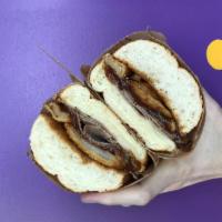 957. Damon Bruce Sandwich · Thinly sliced ribeye, onion rings, steak sauce and provolone cheese.