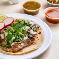 Steak Taco · Grilled chopped tender steak, topped with fresh onions and cilantro, garnish with a lime wed...