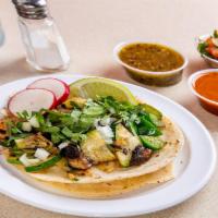 Veggie Taco · A mix of grilled zucchini, portobello mushroom, green peppers, and grilled onions. Tacos top...