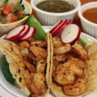 Grilled Shrimp Taco · Topped with pico de gallo, avocado and cotija cheese. Tacos topped with fresh onions and cil...