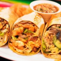 Steak Burrito · Grilled chopped tender steak with Mexican rice, pinto beans, lettuce, Monterrey jack cheese,...