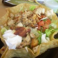Tostada Salad · Choices of grilled protein, lettuce, Mexican rice, frijole bean, jack cheese, sour cream, pi...