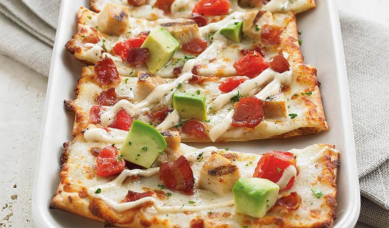 California Club Flatbread · Grilled chicken, applewood smoked bacon, seasoned tomatoes, BJ's signature five cheese blend, avocado, drizzle of roasted garlic aioli