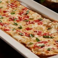 Margherita Fresca Flatbread · Fresh mozzarella, zesty pizza sauce, fresh basil, Parmesan cheese