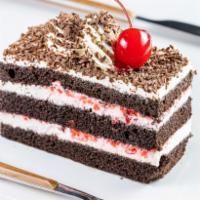Eggless Black Forest · eggless chocolate sponge, cherries, whipped cream and chocolate shavings- a classic cake to ...