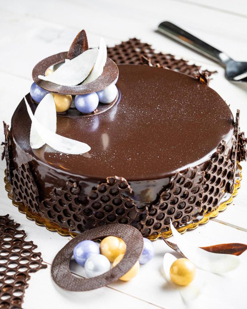 Chocolate Cake · Dream Dark Chocolate- a big bite of rich chocolate layered cake under a creamy chocolate ganache. Nine Inch Cake