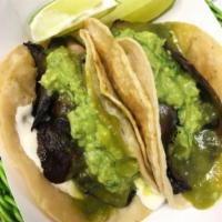 Portobello Tacos · Served with onion, cilantro, Oaxaca cheese, homemade guacamole and tomatillo sauce.