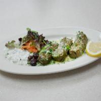 Dolmadaka dinner · Grape leaves stuffed with lean ground beef, lamb, rice and Greek herbs. Topped with avgolemo...