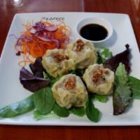 A6. Steamed Thai Dumplings · Stuffed with chicken, shrimp, water chestnuts and mushrooms. Served with house soy sauce.