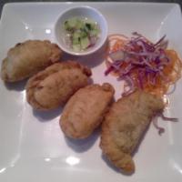 A10. Curry Puff · Stuffed with chicken, potatoes, onions and curry powder with cucumber relish.