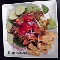 SL1. Thai Salad · Seasonal greens, tomato, cucumber, carrots and tofu served with peanut dressing.