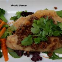 E3. Garlic Sauce · Sauteed fresh garlic and black pepper in brown sauce with steamed mixed vegetables. Served w...