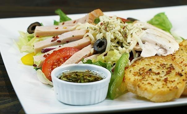 Turkey Salad · Lettuce, tomatoes, cucumber, onions, bell pepper, black olives, cheese, turkey breast and mushrooms. Served with garlic bread. 