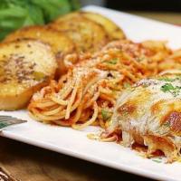 Chicken Parmesan Pasta · Chicken breast topped with onions, mushrooms and cheese with spaghetti.  
