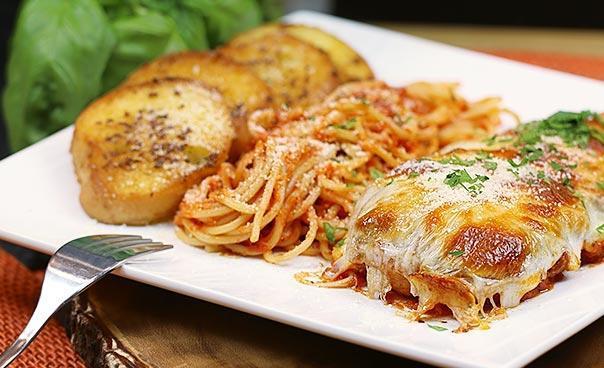 Chicken Parmesan Pasta · Chicken breast topped with onions, mushrooms and cheese with spaghetti.  