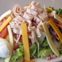 Chef's Salad · Crispy tossed greens with diced ham, turkey strips, cheddar and Monterey​ jack cheese, hard-...