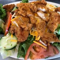 Chicken Strip Salad · Our tender fried chicken strips, hard-boiled eggs, bacon, shredded cheese and tomato slices,...