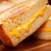 Grilled Cheese Sandwich · Grilled sourdough bread topped with plenty of cheddar and monterey jack cheese.