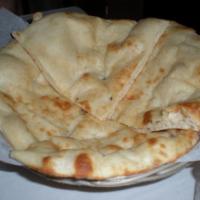 Plain Naan · Leavened bread, traditionally cooked in a clay oven.