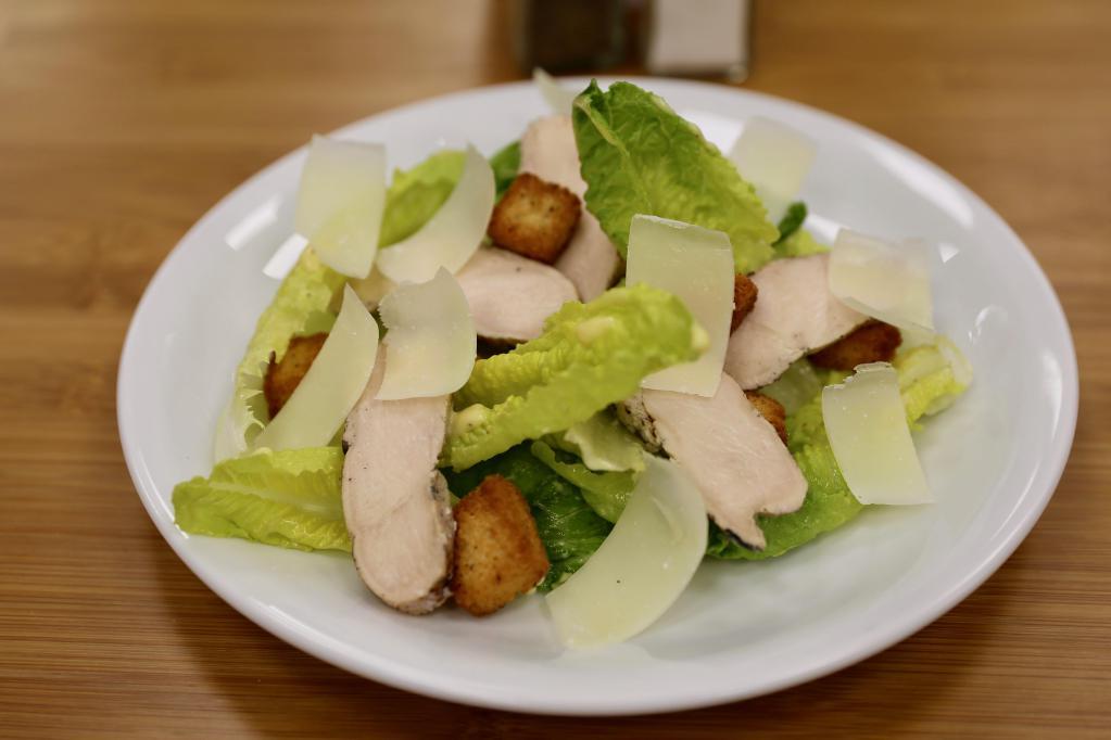 Caesar Salad · Grilled chicken, croutons and shaved Parmesan cheese, romaine with classic Caesar dressing.