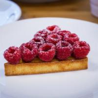 Raspberry Tart · Almond cream in a sweet pastry crust and topped with raspberries.