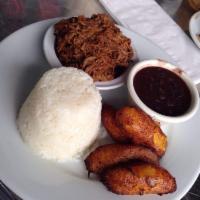 Pabellon Criollo · Shredded meat, black beans, rice, sweet plantains or arepa.