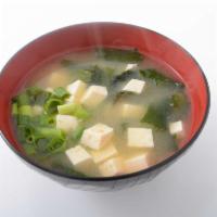 Miso Soup · A traditional savory soybean based soup with diced tofu, green onions and wakame seaweed.