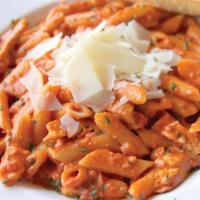 Penne & Grilled Chicken A la Vodka · Penne pasta simmered in a creamy vodka sauce topped with our tender grilled chicken breast, ...