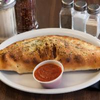 Combination Calzone · Pepperoni, sausage, bell peppers, red onions, mushrooms, ricotta and mozzarella cheese.