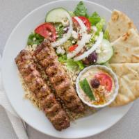 Lamb Kofta Kebab · Ground lamb is marinated with our homemade special spices, served with rice, pita, Greek sal...