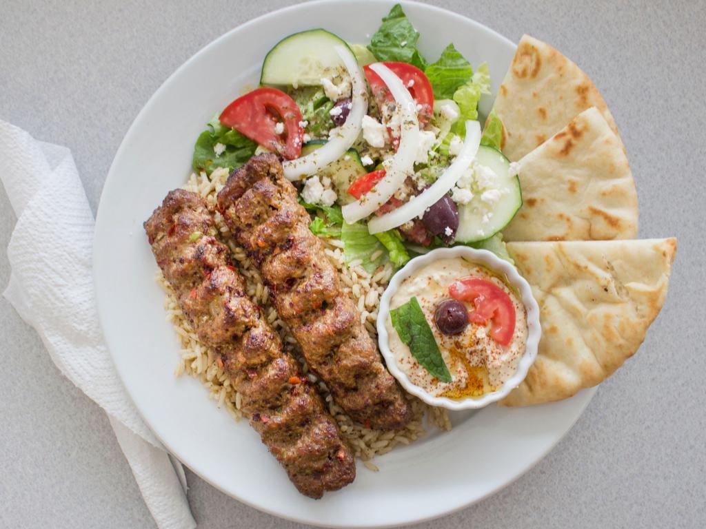Lamb Kofta Kebab · Ground lamb is marinated with our homemade special spices, served with rice, pita, Greek salad and hummus.